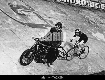 Ex campione del mondo nel motore a ritmo gara Walter Sawall (dietro) con la sua pacer Georges Grolimund durante una gara al Olympiabahn a Berlino. Foto Stock