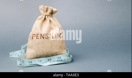 Sacco di denaro con la parola di pensione e di misura di nastro. Autunno / riduzione dei pagamenti pensionistici. Il pensionamento. Finanziamento pensionati. Riduzione del fondo pensione. Th Foto Stock