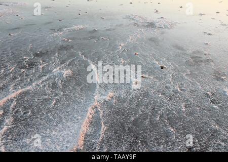 Larnaca, Cipro - Sale di asciugatura sulla riva del lago di sale nella luce del tramonto. Foto Stock