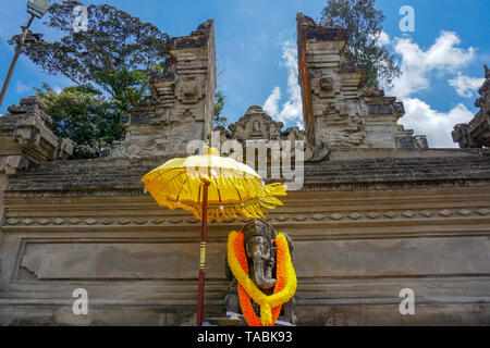 Grande statua di Ganesha con fiori gialli collana e ombrello, Bali, Indonesia Foto Stock