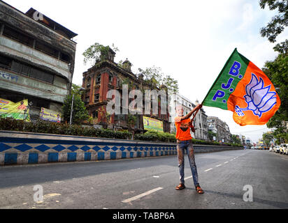 Un sostenitore del Bharatiya Janata Party (BJP) visto indossare una maschera di Narendra modi durante la tessitura BJP bandiere nella parte anteriore della testa di partito quarto in Kolkata dopo la massiccia vincere nel Bengala occidentale e in India elezioni. Bharatiya Janata Party (BJP) vince le elezioni in Kolkata, India. Foto Stock