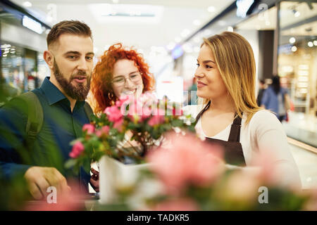 Shop Consulenza assistente giovane nel negozio di fiori Foto Stock