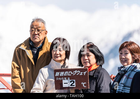 Takayama, Giappone - Aprile 8, 2019: Montagna neve in villaggi Okuhida Shinhotaka funivia con famiglia turistica in posa Holding firmano Prefettura di Gifu park su Foto Stock