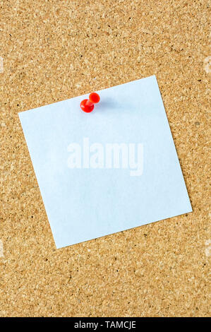 Small white piece of paper on pin board as a template Foto Stock