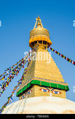 La cupola e oro guglia di Bodhnath Stupa, Kathmandu, Nepal, con bandiere da preghiera buddista. Foto Stock