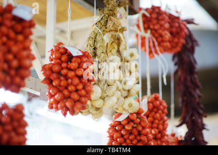 Mazzetti di aglio organico e i pomodori ciliegia venduto su un mercato in Genova, liguria, Italy Foto Stock