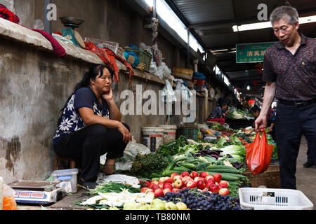 28 luglio 2018 Kunming, in Cina- Lady vende verdura nel mercato alimentare Foto Stock