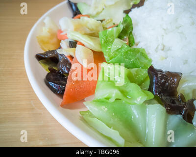 Una lastra di Kung Pao pollo con riso coleslaw Foto Stock