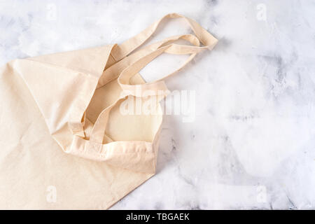 Tessuto bianco borsa su sfondo di cemento. Vista superiore Foto Stock