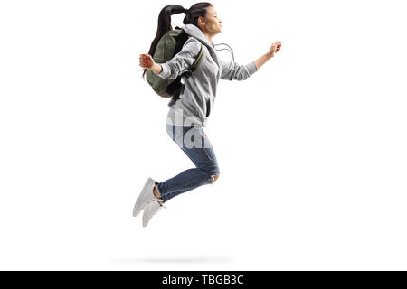 Lunghezza piena ripresa del profilo di una giovane studentessa jumping isolati su sfondo bianco Foto Stock