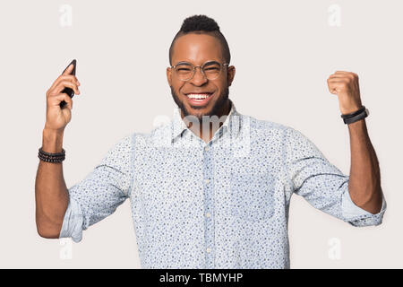 Sorpreso uomo nero confuso dal messaggio inatteso sullo smartphone Foto Stock