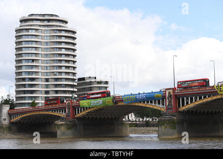 Attivista di Amnesty International distendere anti-Trump banner da Vauxhall Bridge in vista dell'Ambasciata degli Stati Uniti a Londra centrale, il giorno uno di noi presidente Donald Trump's visita di Stato nel Regno Unito. Foto Stock