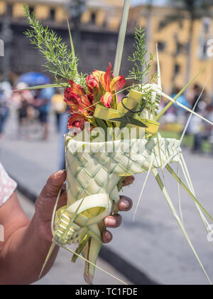 Lima, Perù - Marzo 29, 2018: Donna Peruviana che mostra una Pasqua palm sulla strada di Lima prima di Pasqua. Buon Venerdì. Plaza de Armas, Perù, così Foto Stock