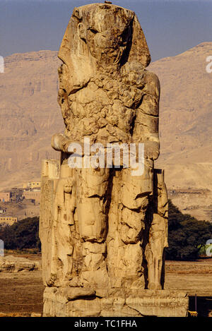 Luxor, Egitto. Il West (o sud) Colosso di Memnon, uno dei due enormi statue di pietra del faraone Amenhotep III in piedi nella necropoli tebana Foto Stock