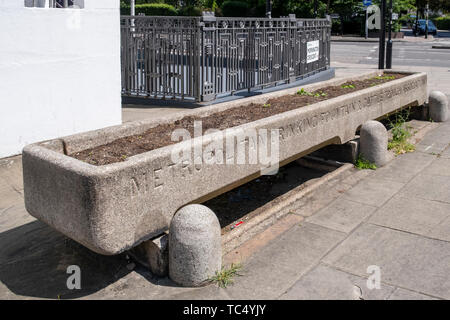 Metropolitan in disuso Fontanella e Bestiame Associazione Trogolo di pietra il canale di bestiame al Mornington Crescent a Londra in Inghilterra ora una cassetta per fiori Foto Stock