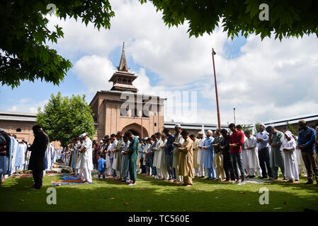 Musulmani del Kashmir adoratori offrendo Eid-ul-Fitr preghiera alla madrassa Jamia Masjid in Srinagar. Eid-ul-Fitr festival segna la fine del Santo mese di digiuno del Ramadan. Foto Stock