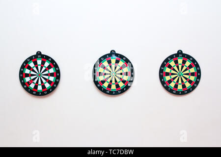 Dartboard con un dardo su un muro grigio vicino. Il gioco delle freccette Foto Stock