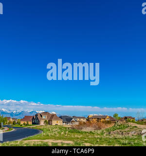 Telaio quadrato Panorama di una collina con una strada tortuosa e belle case in una giornata di sole Foto Stock