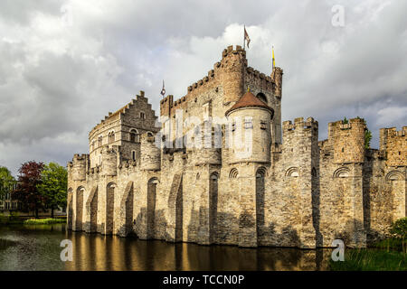 Mura fortificate e torri di Gravensteen medievale castello con fossato in primo piano, Gand Fiandre Orientali, Belgio Foto Stock