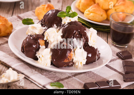 Profiterole al cioccolato. Foto Stock