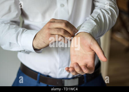 Nozze sposo mattina preparati, dress up con camicia bianca, abbottonatura fino Foto Stock