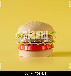 Hamburger di plastica, insalata di pomodoro, carne con il giallo. Concetto di nocivi cibi artificiali. Plastica. Foto Stock