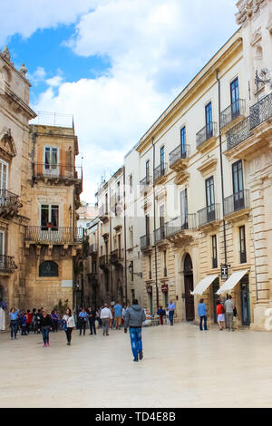 Siracusa, Sicilia, Italia - 10 Apr 2019: turisti camminando sulla Piazza Duomo Square nella città vecchia. Il centro storico della bella città è situato sulla famosa isola di Ortigia. Spot popolare. Foto Stock