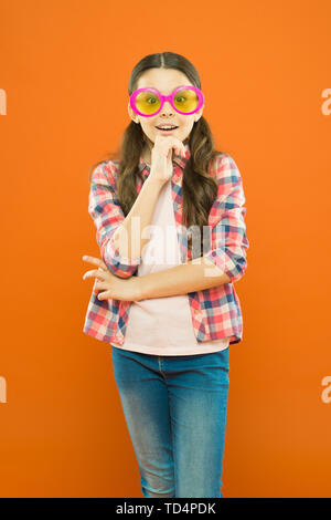 Ottica e la vista di trattamento. Effettivo esercizio occhi lo zoom. Bambino felice con buona visione. La vista e la salute dell'occhio. Migliorare la vista. Occhiali da sole accessorio di fantasia. Ragazza ragazzo indossare occhiali. Foto Stock