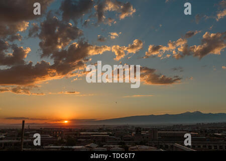 Foto del tramonto e nuvole nonché le infrastrutture della piccola città Foto Stock