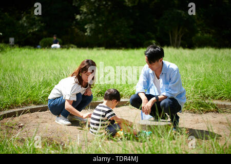 Famiglia giapponese in un parco della città Foto Stock