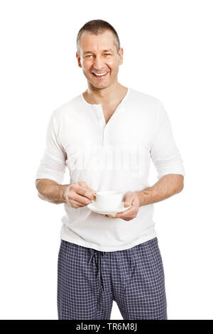 Uomo bello in pigiama pantaloni con una tazza di caffè, Germania Foto Stock