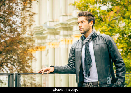 Giovane uomo attraente con la giacca di pelle nella città, Germania Foto Stock
