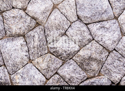La texture del muro fatto di grandi dimensioni il granito Foto Stock