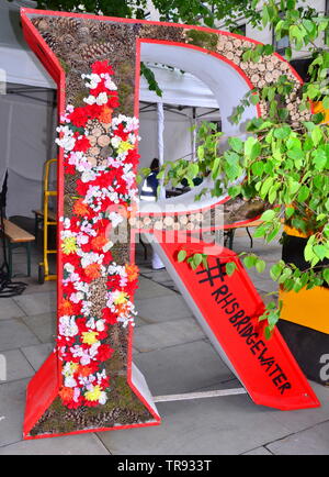 La Manchester Flower Show, parte di Manchester's King Street Festival il 1 giugno - 2nd, 2019, si prepara ad aprire. Il tema di quest'anno:Flower Power! Il Royal Horticultural Society in stallo decora la sua sigla in fiori - questo è il R. Foto Stock