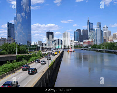 Lo skyline di Philadelphia in 2019 con expressway sul lato ovest del fiume Schuylkill e ricreativo boardwalk lungo l'altra banca per ciclisti e Foto Stock