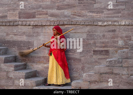 Donna in Sari la pulizia dei passaggi a Toorji Ka Jhalara, la fase ben, Jodhpur, Rajasthan, India Foto Stock