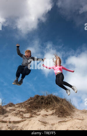 Saltando i bambini nelle dune su Texel, Paesi Bassi, Texel, De Slufter Foto Stock