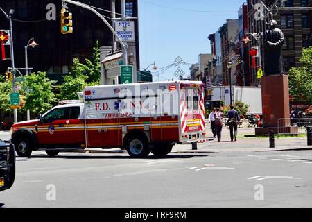 FDNY, dei Vigili del Fuoco di New York ambulanza intitolata a un'emergenza, passando attraverso una Chinatown intersezione dalla piazza Kimlau , Manhattan, NY, STATI UNITI D'AMERICA. Foto Stock