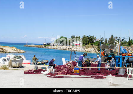 Pescatori tendono le loro reti nel piccolo porto di Nea Potidea, Halkidiki, Grecia, Foto Stock