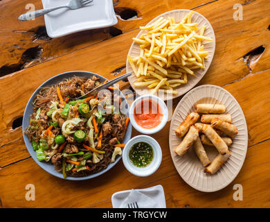 Pasto filippino, Pancit Sotanghon, tonno involtini primavera e patatine fritte. Foto Stock