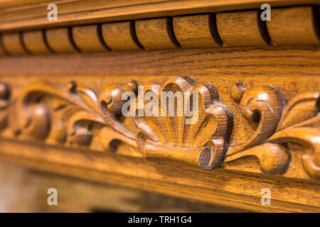 Close-up di dettaglio in legno intagliato pezzo decorativo di mobili con ornamenti floreali realizzati in legno naturale. Arte e Artigianato di design. Foto Stock