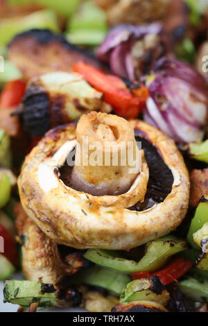 Vegano verdure grigliate con seitan, funghi, zucchine, pomodori e peperoni Foto Stock