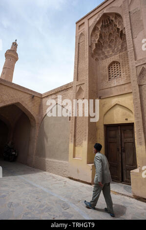 Un uomo che cammina al di fuori della Nain grande moschea o 'Masjed-e Jame' Nain' in persiano, è una congregazione moschea e uno di Iran del più antico. Esso originariamente data Foto Stock