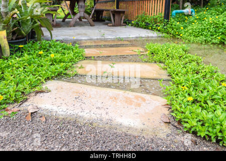 Pietra Passerella curva nel giardino ombreggiato Foto Stock