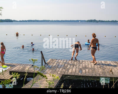 La gente di nuoto nel Spiegelplas ('Mirrorlake"), creato da estrazione di sabbia, in Nederhorst den Berg, Paesi Bassi. Foto Stock