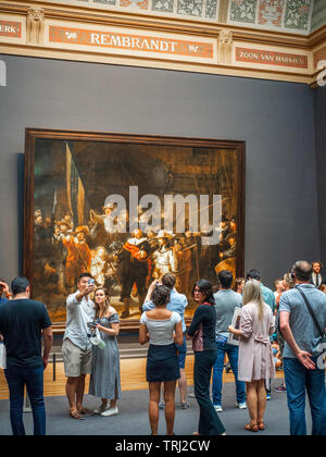 Tourist osservando la guardia notturna, un dipinto di Rembrandt Harmenszoon van Rijn, presso il Rijksmuseum di Amsterdam, Paesi Bassi. Rembrandt è consi Foto Stock