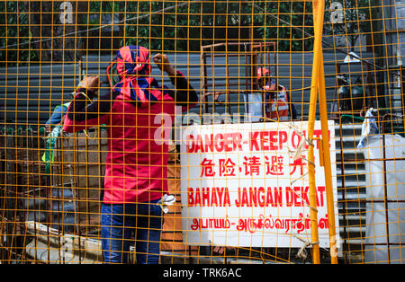 Singapore-02 APR 2019：Lavoratore che indossa il Milan sciarpa in sito in costruzione Foto Stock