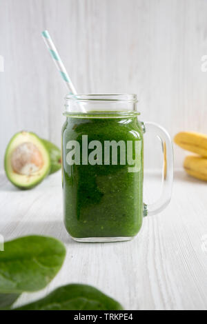 Frullato di verde con spinaci, avocado e banana in un vasetto di vetro, vista laterale. Primo piano. Foto Stock