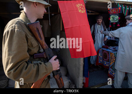 Esercito sovietico soldati nel mercato afghano durante la guerra in Afghanistan(1979-1989). Ricostruzione storica durante il festival "tempi e epoche' in Mosca Foto Stock