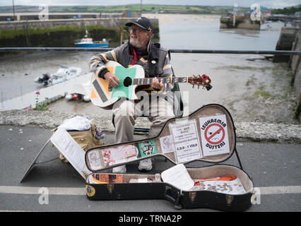 Breezy una carità busker sulla banchina a Padstow Cornwall per raccogliere per la leucemia Busters Foto Stock